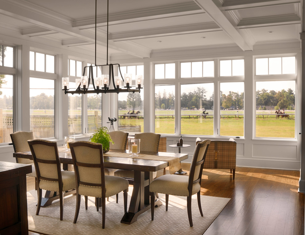 Inspiration for a large traditional kitchen/dining combo with white walls, medium hardwood floors, coffered and panelled walls.