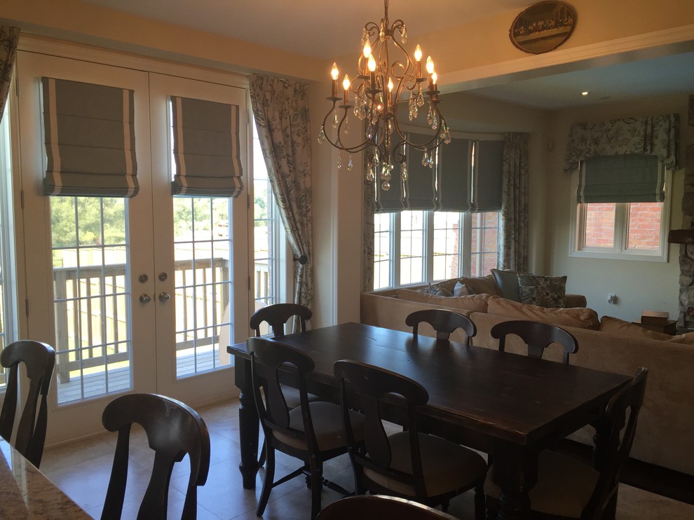 This is an example of a mid-sized transitional open plan dining in Toronto with porcelain floors and black floor.