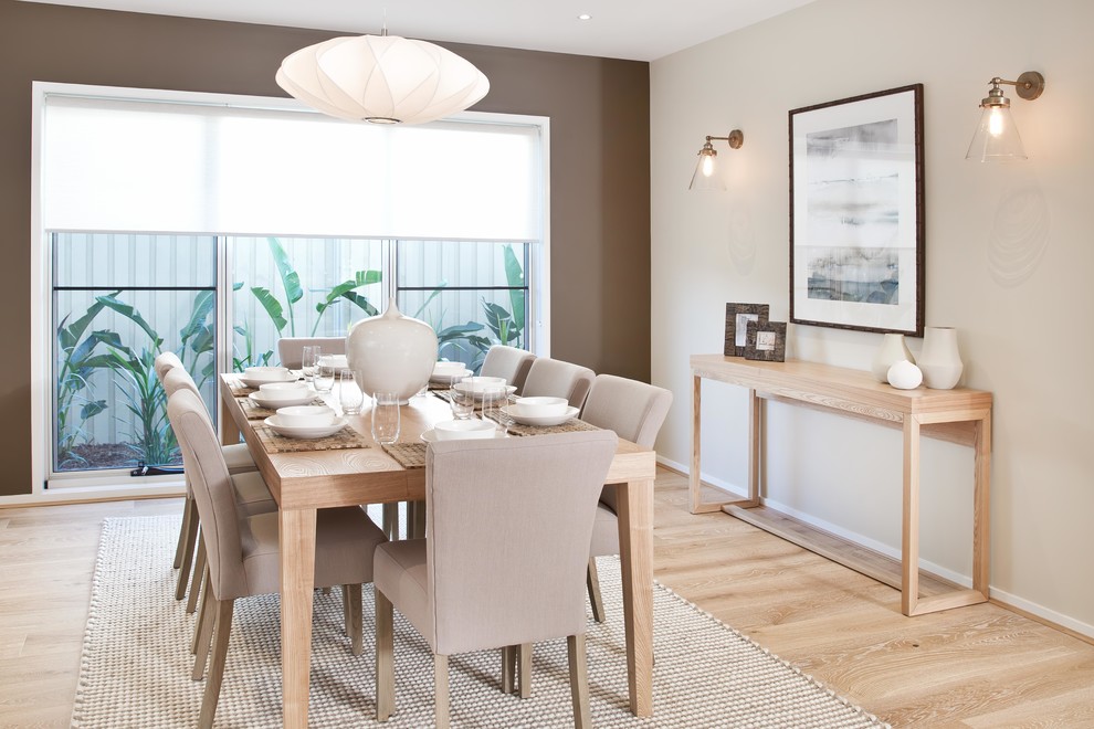 Design ideas for a mid-sized contemporary open plan dining in Sunshine Coast with beige walls and light hardwood floors.