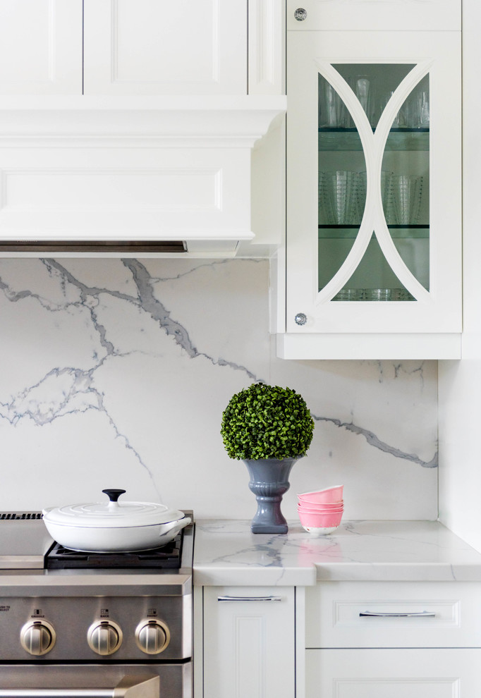 Inspiration for a mid-sized traditional l-shaped open plan kitchen in San Diego with a double-bowl sink, shaker cabinets, white cabinets, white splashback, stone slab splashback, stainless steel appliances, marble floors and with island.