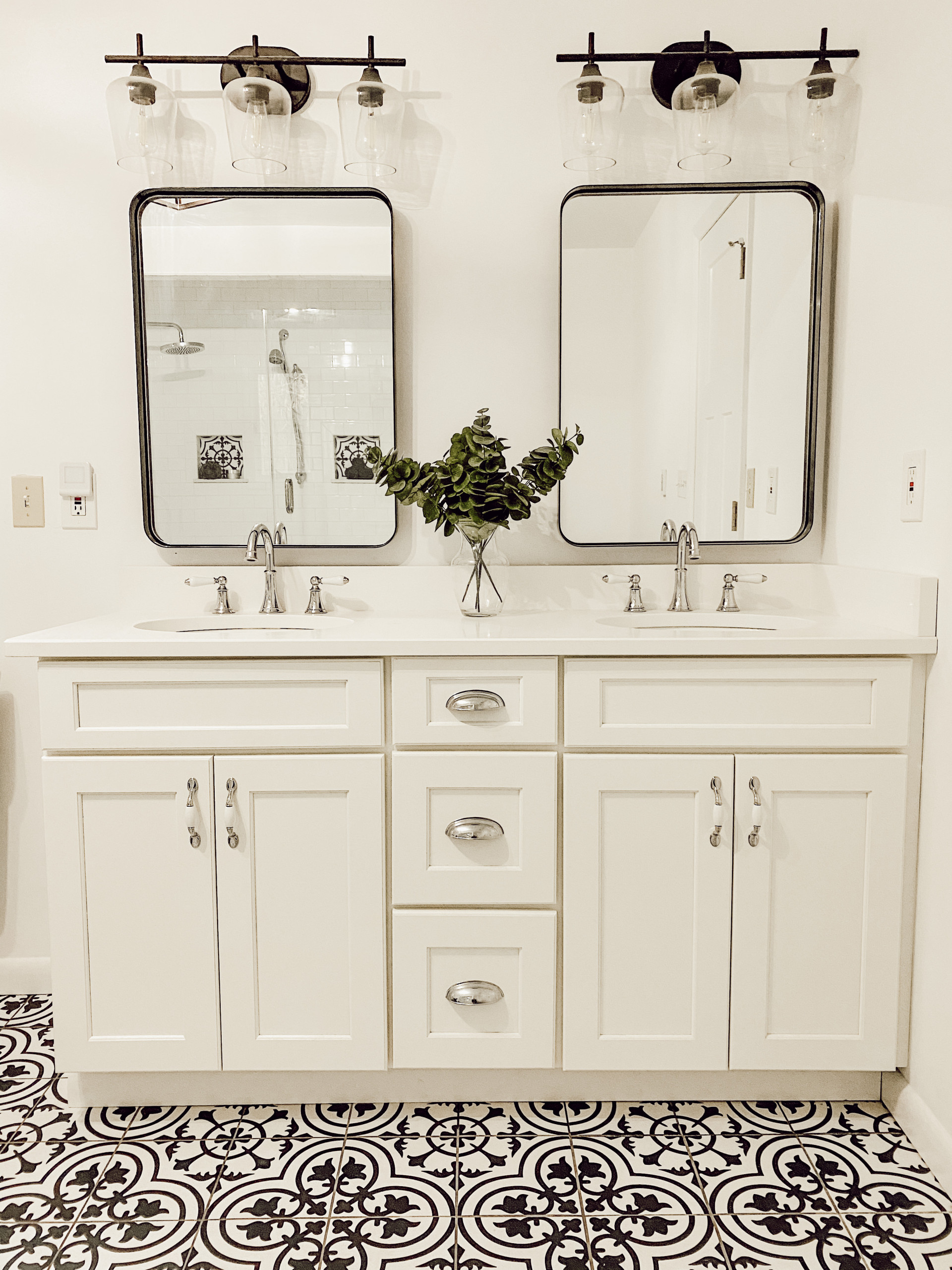 Mid-sized master ceramic tile, multicolored floor and double-sink freestanding bathtub photo in New York with shaker cabinets, white cabinets, a one-piece toilet, white walls, an undermount sink, gran