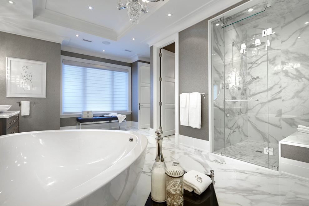 This is an example of an expansive transitional master bathroom in Detroit with a vessel sink, furniture-like cabinets, medium wood cabinets, marble benchtops, a freestanding tub, a curbless shower, a one-piece toilet, white tile, porcelain tile, multi-coloured walls and porcelain floors.