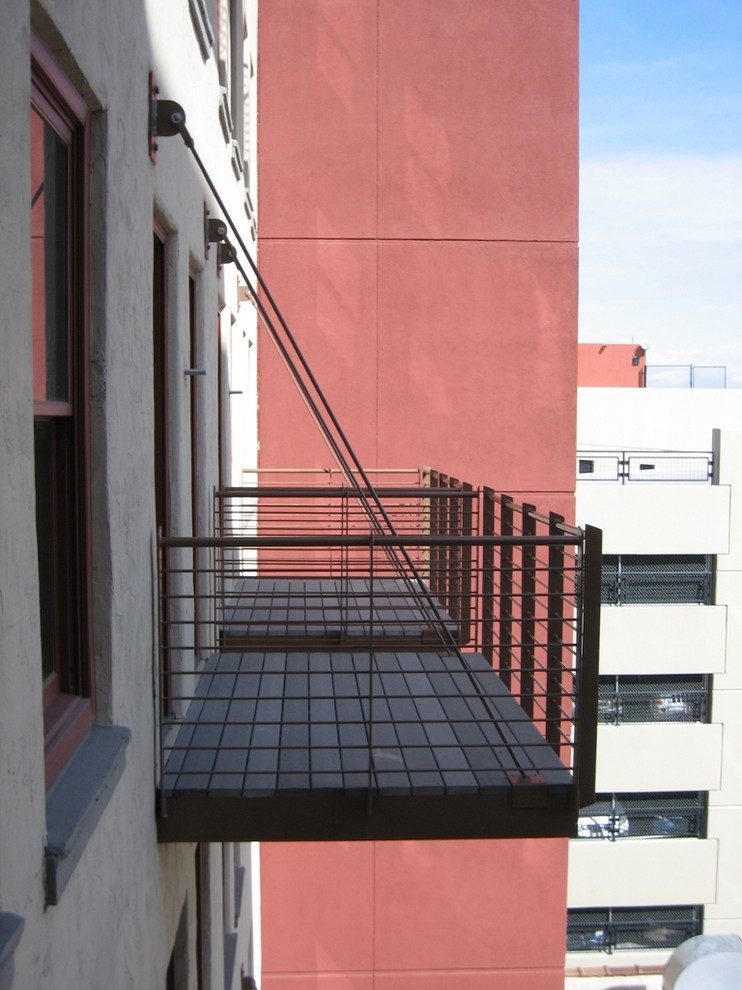 This is an example of a modern balcony in Albuquerque with no cover and metal railing.