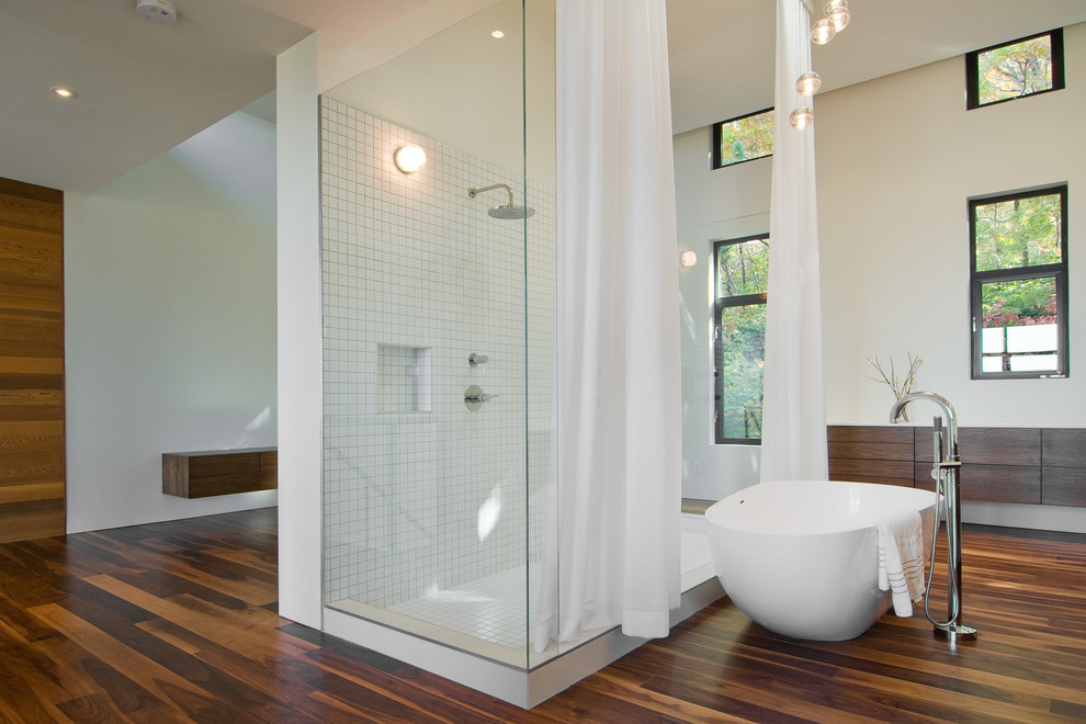 Contemporary wet room bathroom in Seattle with flat-panel cabinets, dark wood cabinets, a freestanding tub, white tile, mosaic tile, white walls, dark hardwood floors, brown floor and a shower curtain.