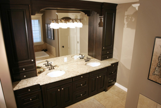 Inspiration for a large contemporary master bathroom in Calgary with raised-panel cabinets, dark wood cabinets, a drop-in tub, beige tile, beige walls, ceramic floors, a drop-in sink and granite benchtops.