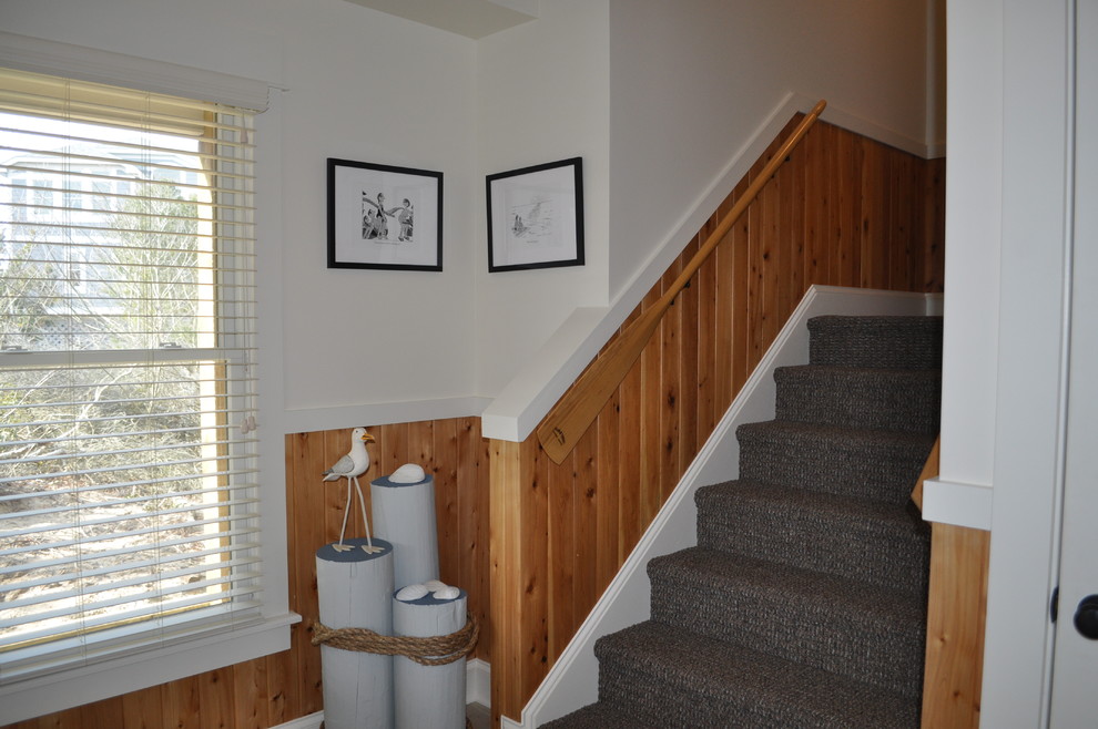 Mid-sized beach style carpeted u-shaped staircase in Other with carpet risers.