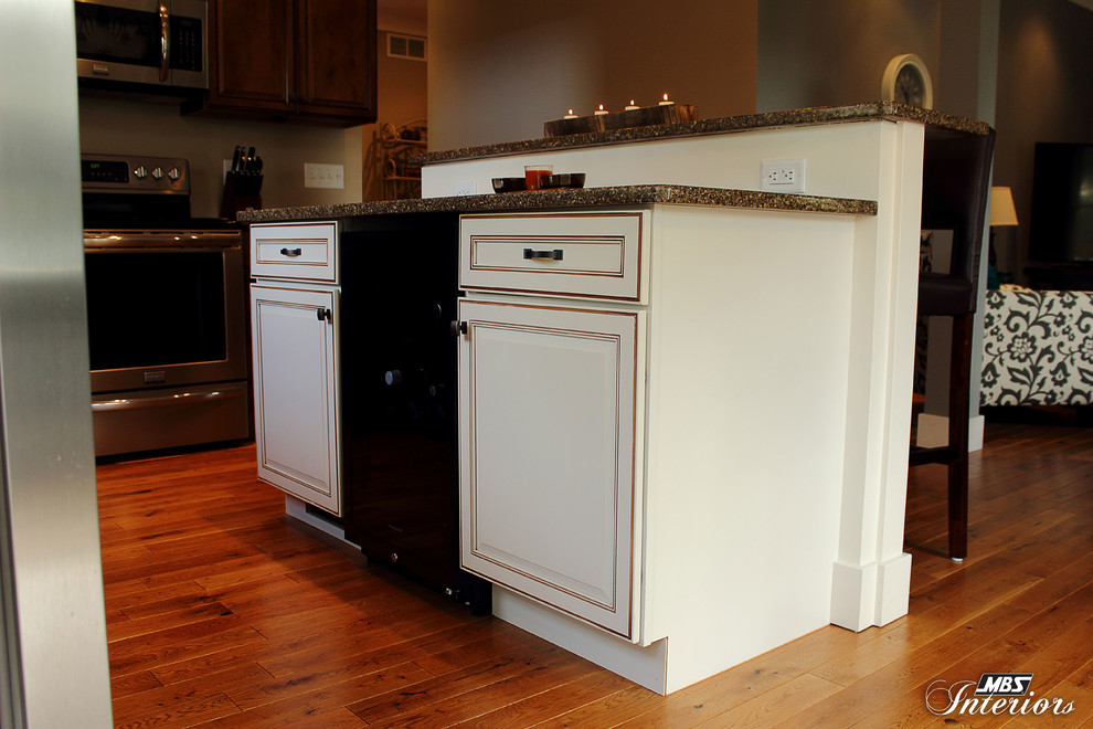 Kitchen - transitional l-shaped kitchen idea in Columbus with an undermount sink, recessed-panel cabinets, medium tone wood cabinets, quartz countertops, stainless steel appliances and an island