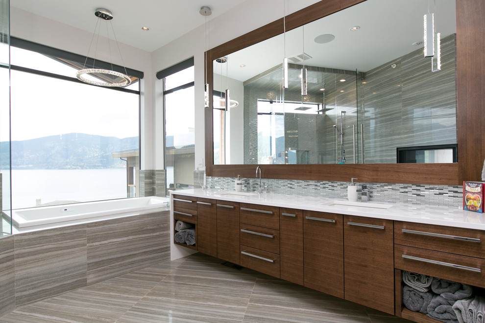 Inspiration for a contemporary master bathroom in Vancouver with flat-panel cabinets, dark wood cabinets, a drop-in tub, a corner shower, gray tile, grey walls, an undermount sink and engineered quartz benchtops.