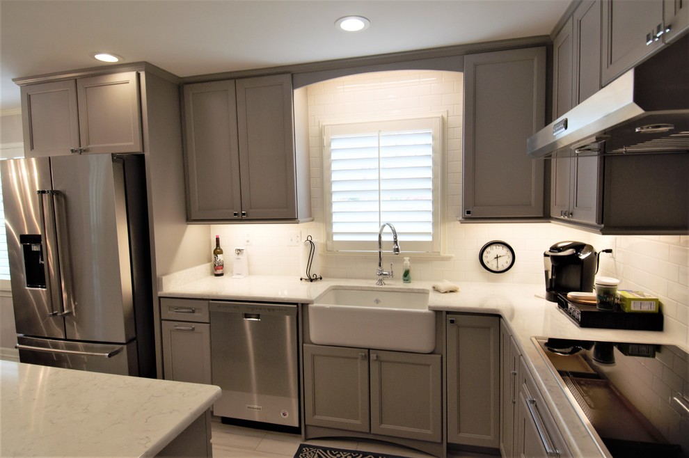 Eat-in kitchen - large transitional u-shaped porcelain tile and beige floor eat-in kitchen idea with a farmhouse sink, recessed-panel cabinets, gray cabinets, granite countertops, white backsplash, subway tile backsplash, stainless steel appliances, an island and beige countertops