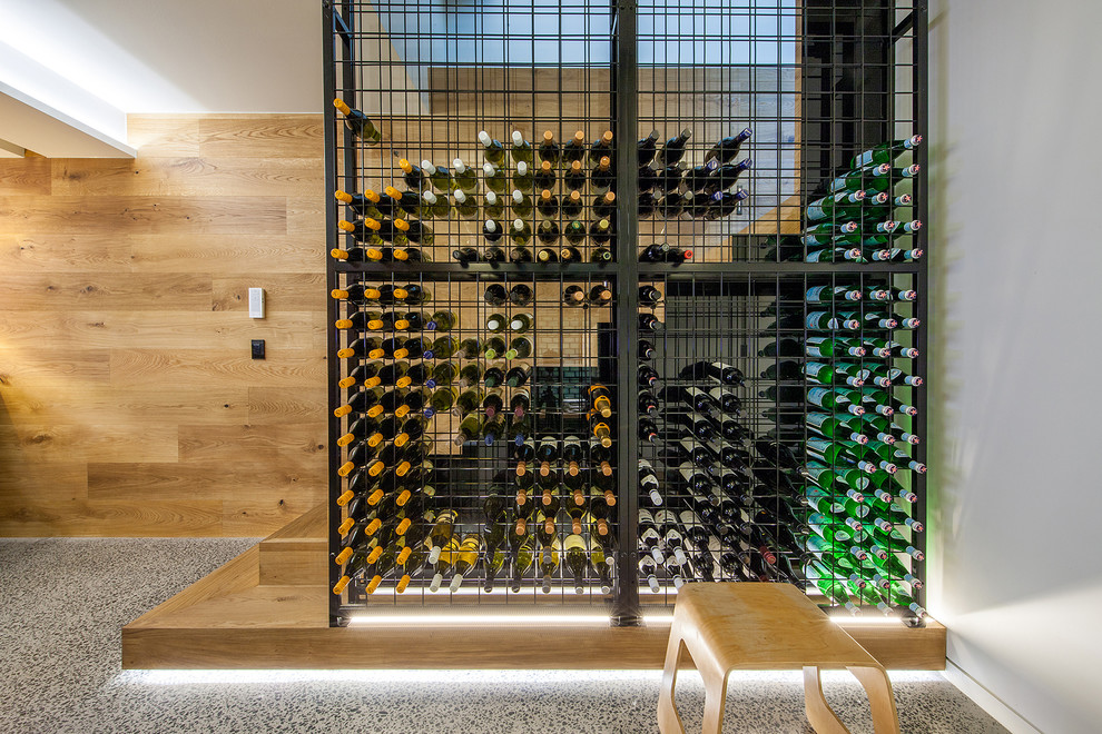 Design ideas for a contemporary wine cellar in Sydney with storage racks.