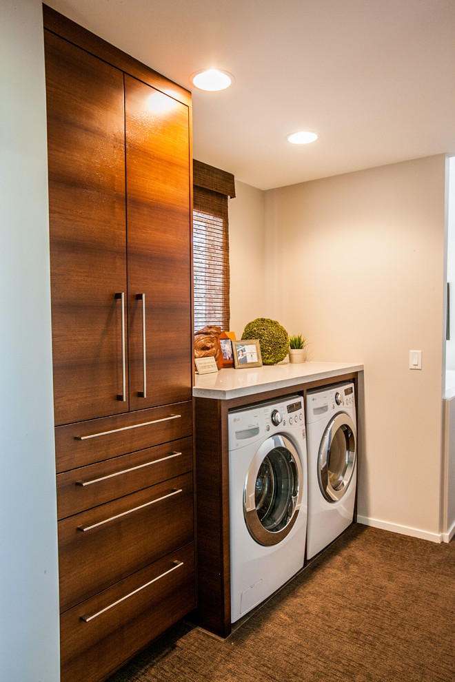 Design ideas for a small contemporary single-wall dedicated laundry room in Salt Lake City with flat-panel cabinets, dark wood cabinets, quartz benchtops, beige walls, a side-by-side washer and dryer and carpet.