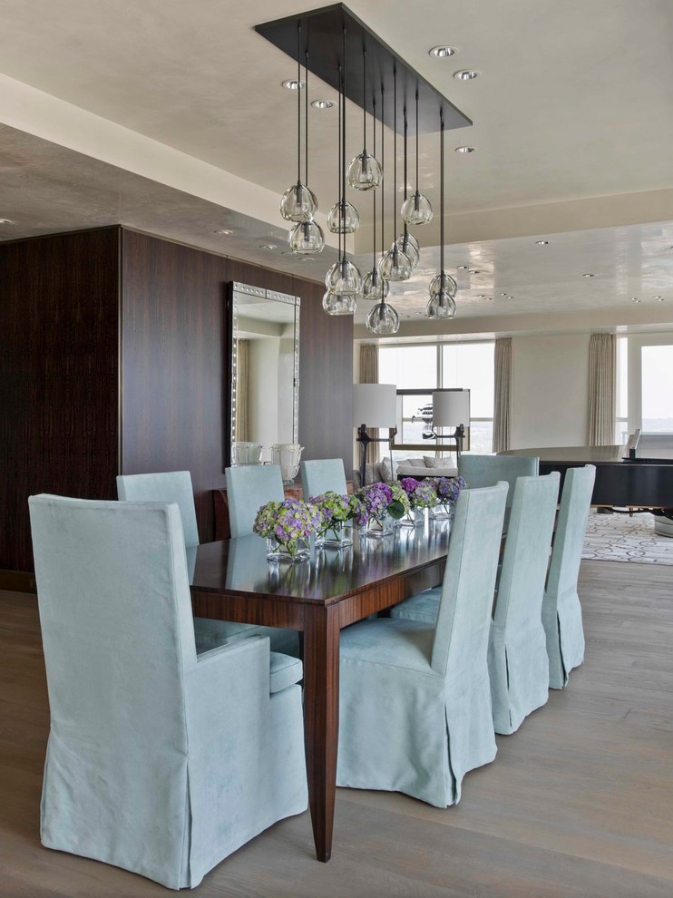 This is an example of a contemporary open plan dining in Austin with beige walls and medium hardwood floors.