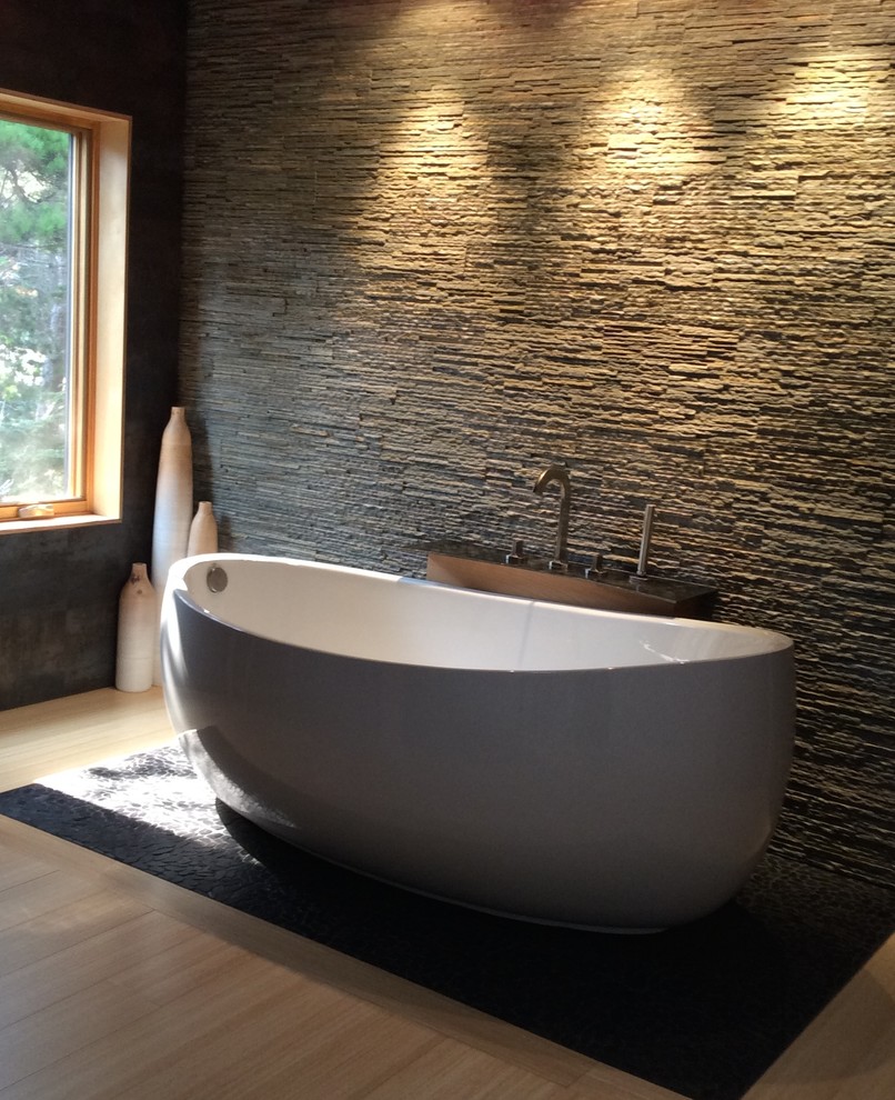 Large industrial master bathroom in Other with a freestanding tub, a double shower, a two-piece toilet, black tile, porcelain tile, white walls, bamboo floors, a trough sink and concrete benchtops.