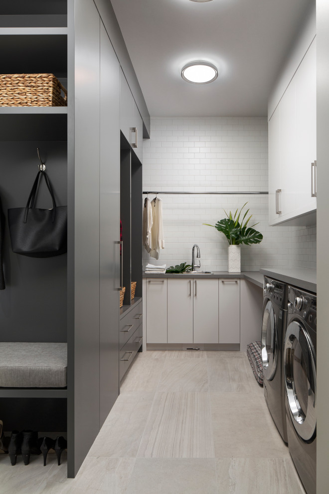 Inspiration for a mid-sized contemporary utility room in Calgary with flat-panel cabinets, laminate benchtops, porcelain floors and a side-by-side washer and dryer.