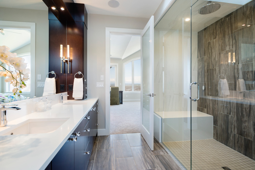 Inspiration for a large transitional master bathroom in Vancouver with an undermount sink, flat-panel cabinets, dark wood cabinets, engineered quartz benchtops, a curbless shower, a one-piece toilet, grey walls and porcelain floors.