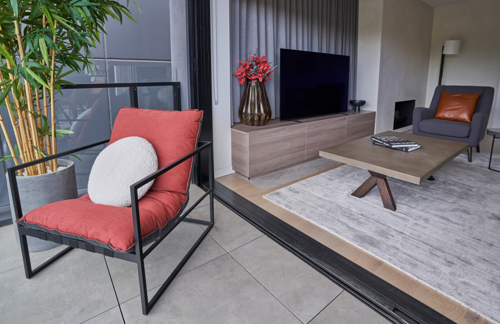 Example of a mid-sized trendy loft-style medium tone wood floor family room design in Melbourne with a standard fireplace, a concrete fireplace and a tv stand