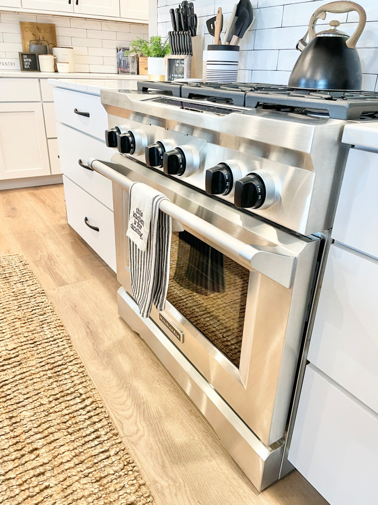 White, Black, and White Oak Open Concept Kitchen and Pantry in