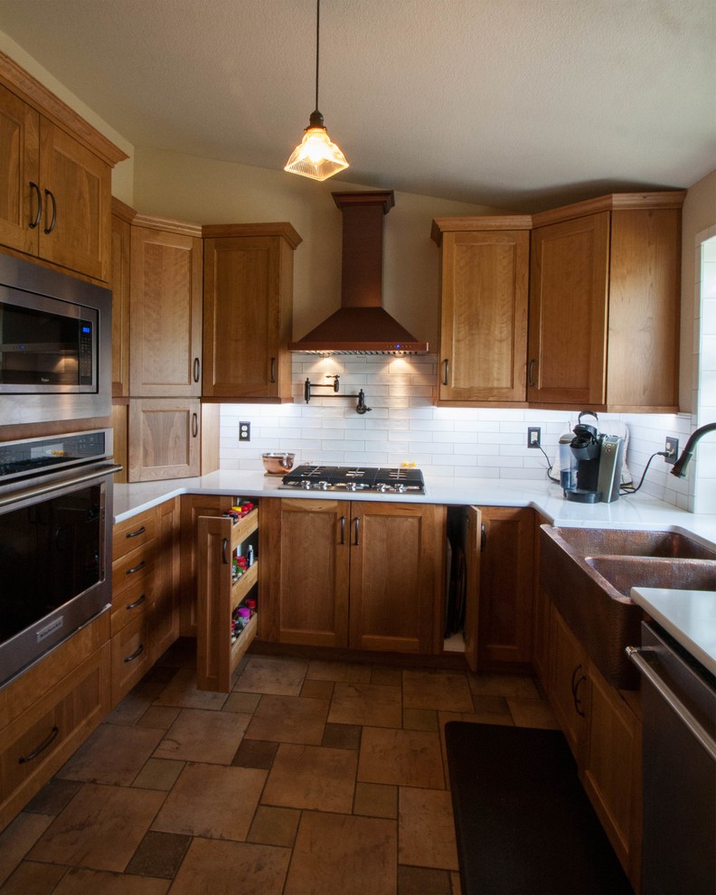 Example of a small transitional u-shaped terra-cotta tile and red floor eat-in kitchen design in Seattle with a farmhouse sink, recessed-panel cabinets, brown cabinets, quartz countertops, white backsplash, ceramic backsplash and no island
