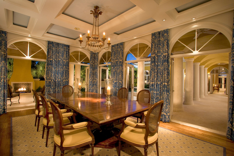 Photo of a mediterranean separate dining room in Miami with medium hardwood floors.