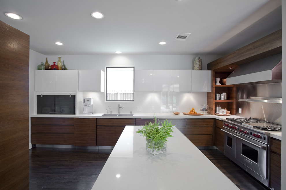 This is an example of a contemporary kitchen in Dallas with stainless steel appliances, a double-bowl sink, flat-panel cabinets, white splashback and glass sheet splashback.