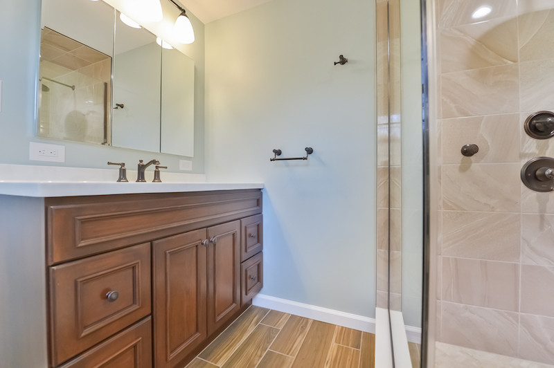 Photo of a medium sized contemporary ensuite bathroom in Philadelphia with a corner shower, a hinged door, a single sink and a built in vanity unit.