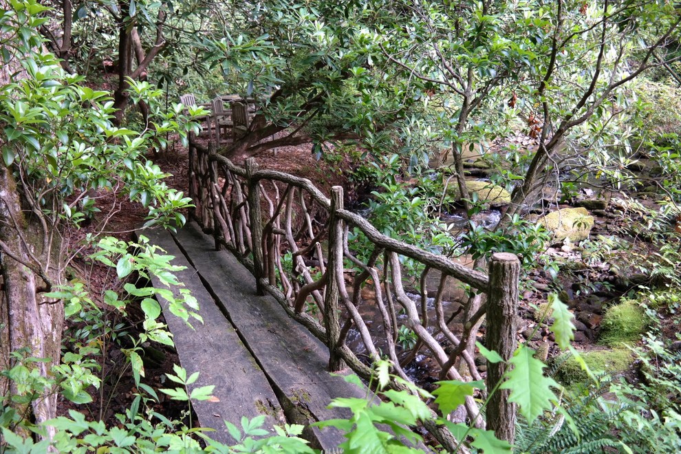 This is an example of a mid-sized rustic shade backyard garden path with decking for spring.