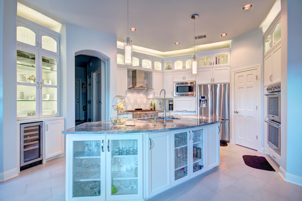 Large transitional u-shaped porcelain tile eat-in kitchen photo in Austin with an undermount sink, recessed-panel cabinets, white cabinets, marble countertops, gray backsplash, mosaic tile backsplash, stainless steel appliances and an island