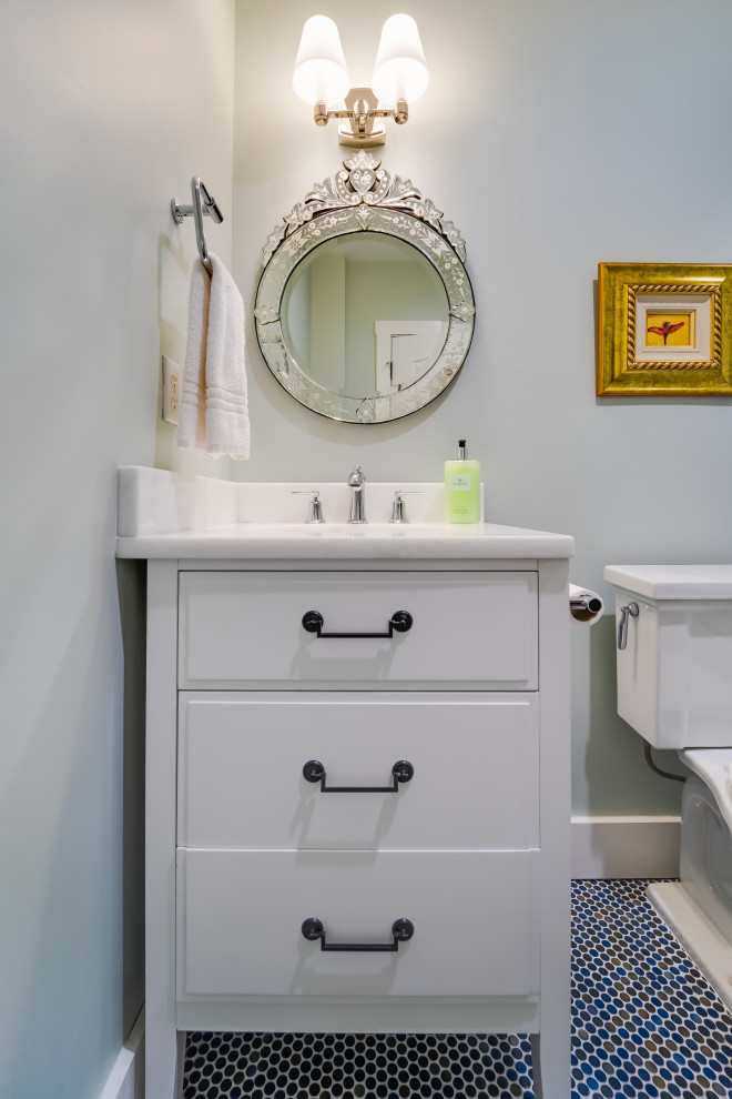 This is an example of a mid-sized country 3/4 bathroom in Miami with flat-panel cabinets, white cabinets, a drop-in tub, an alcove shower, a two-piece toilet, white tile, ceramic tile, green walls, ceramic floors, an undermount sink, marble benchtops, multi-coloured floor, a sliding shower screen, white benchtops, a niche, a single vanity and a freestanding vanity.