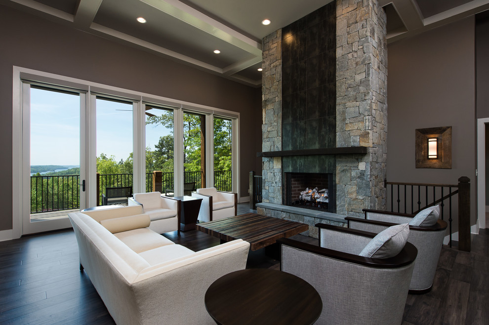 Large modern formal open concept living room in Other with dark hardwood floors, a stone fireplace surround, no tv, brown walls and a standard fireplace.