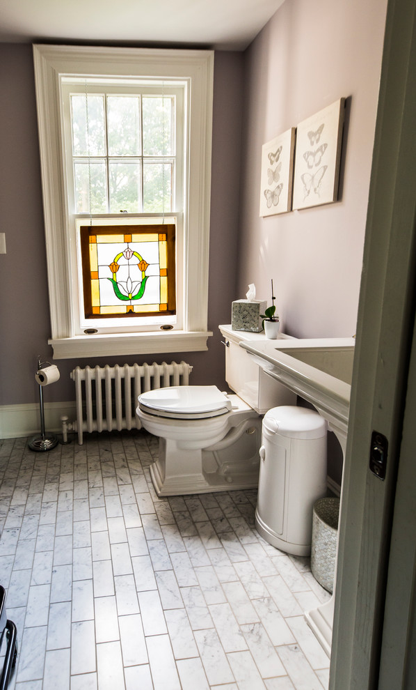 This is an example of an arts and crafts 3/4 bathroom in Philadelphia with white cabinets, purple walls, a pedestal sink and white floor.