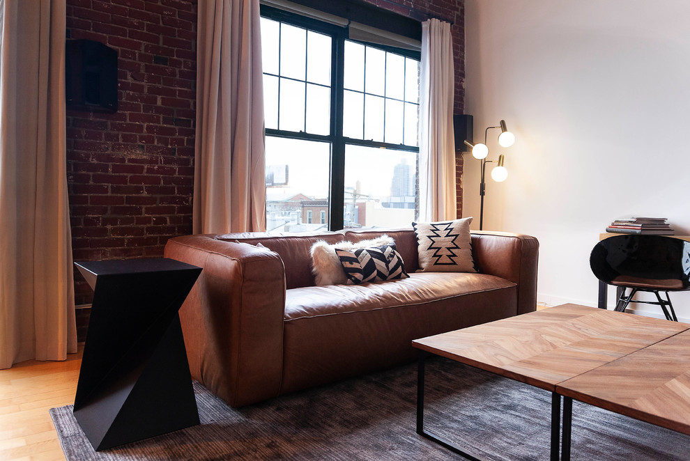 Inspiration for a small industrial formal and open concept medium tone wood floor and brown floor living room remodel in Philadelphia with white walls, no fireplace and a tv stand