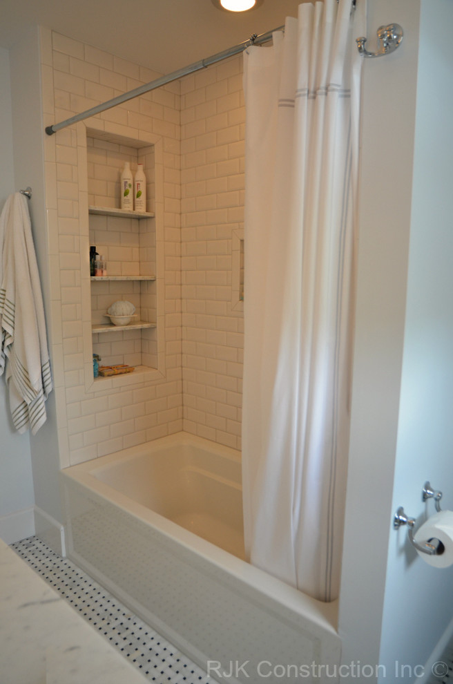 Traditional bathroom in DC Metro with a shower/bathtub combo and white tile.