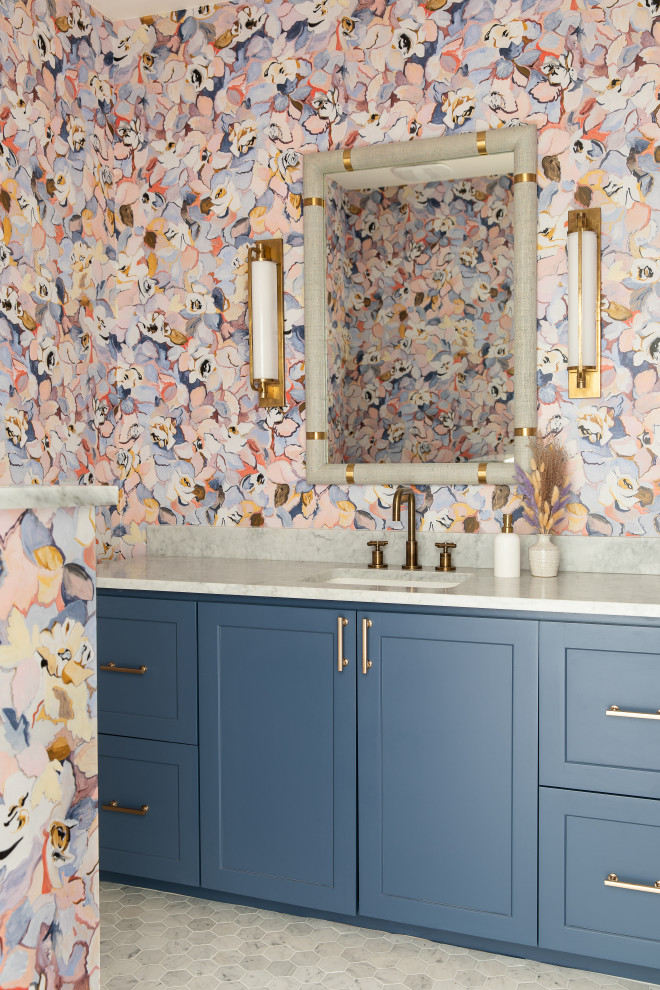Design ideas for a transitional powder room in Austin with shaker cabinets, blue cabinets, multi-coloured walls, marble floors, an undermount sink, marble benchtops, grey floor, a built-in vanity and wallpaper.