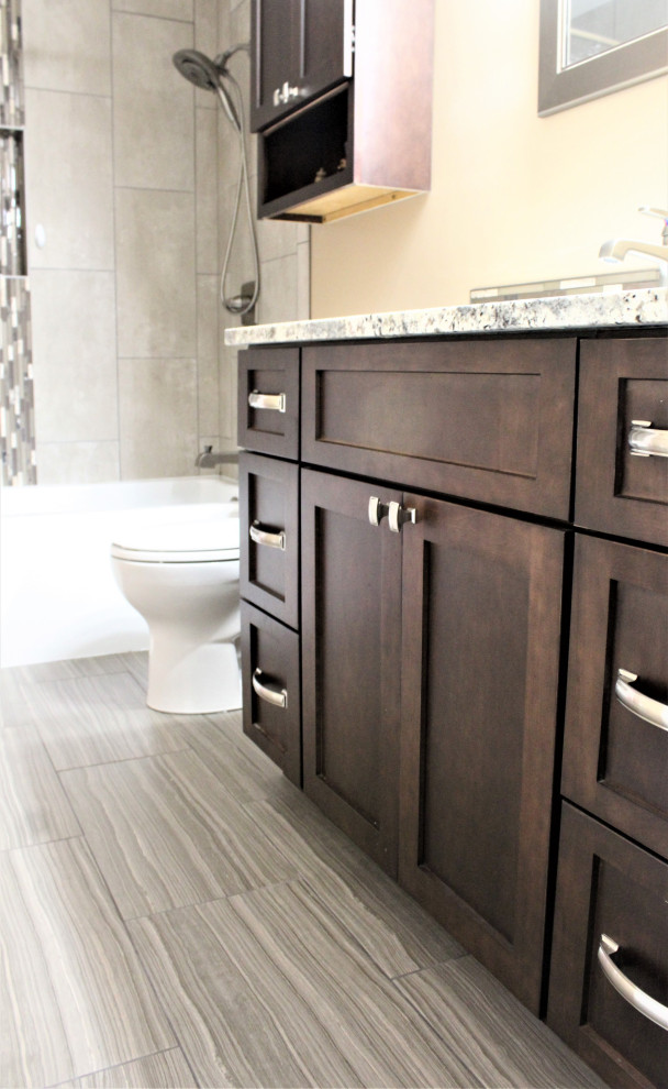 Mid-sized transitional master bathroom in Detroit with shaker cabinets, brown cabinets, an alcove tub, an alcove shower, beige tile, ceramic tile, beige walls, porcelain floors, an undermount sink, granite benchtops, brown floor, a shower curtain, brown benchtops, a single vanity and a freestanding vanity.