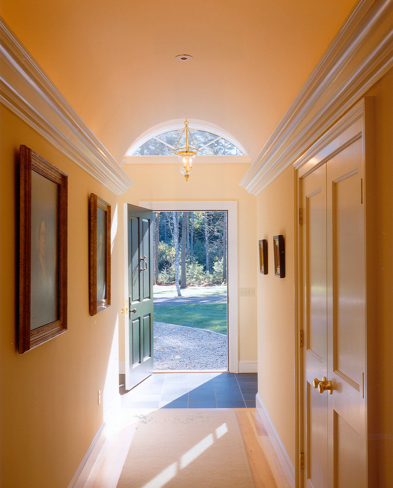Photo of a traditional entryway in Portland Maine with yellow walls.