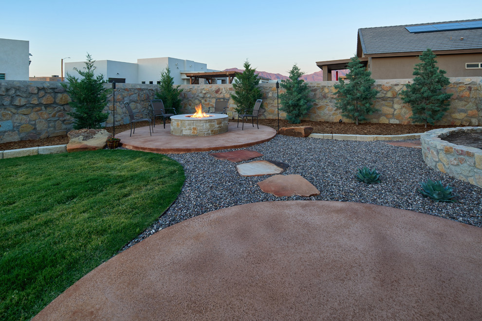 Design ideas for a mid-sized traditional backyard full sun xeriscape in Other with a fire feature and concrete pavers.