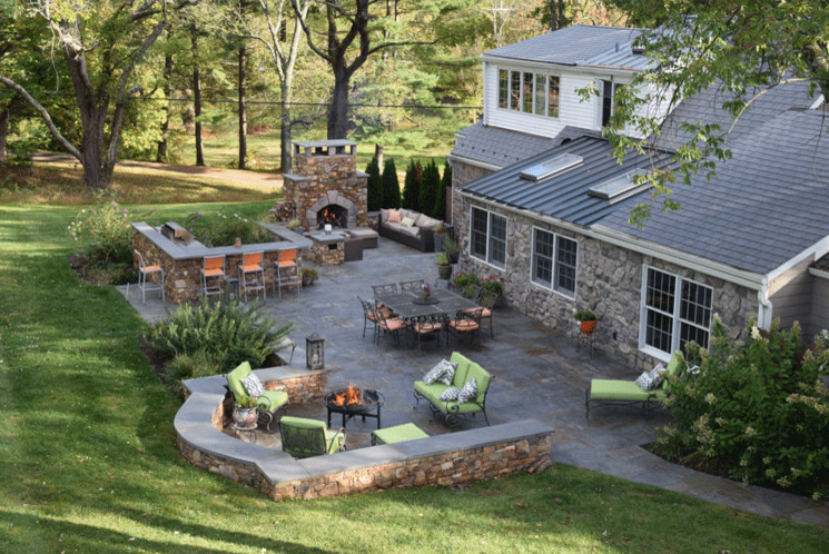 Inspiration for a large arts and crafts backyard patio in Philadelphia with a fire feature, concrete pavers and no cover.