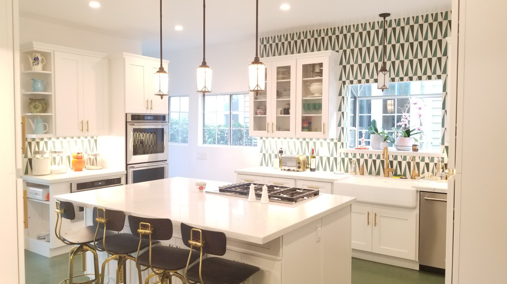 Design ideas for a large contemporary galley eat-in kitchen in Los Angeles with a farmhouse sink, shaker cabinets, white cabinets, quartzite benchtops, green splashback, cement tile splashback, stainless steel appliances, linoleum floors, with island, green floor and white benchtop.