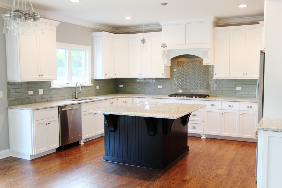 Inspiration for a large transitional u-shaped medium tone wood floor eat-in kitchen remodel in Chicago with a double-bowl sink, shaker cabinets, white cabinets, granite countertops, green backsplash, glass tile backsplash, stainless steel appliances and an island
