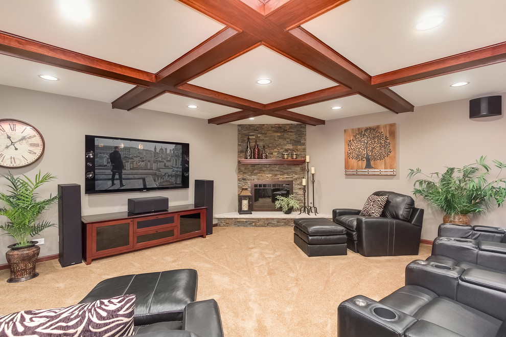 Design ideas for a large traditional fully buried basement in Chicago with grey walls, carpet, a standard fireplace, a stone fireplace surround and beige floor.