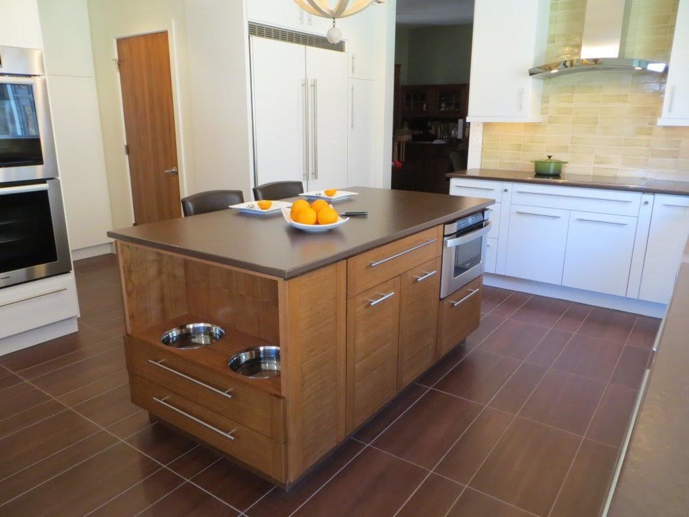 Photo of a mid-sized transitional u-shaped separate kitchen in New York with a farmhouse sink, flat-panel cabinets, white cabinets, quartz benchtops, beige splashback, ceramic splashback, panelled appliances, porcelain floors and with island.