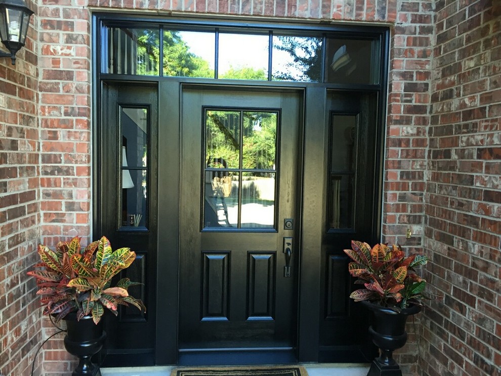 Small traditional front door in Dallas with multi-coloured walls, brick floors, a single front door and a black front door.