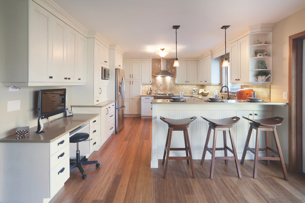 Inspiration for a large transitional u-shaped medium tone wood floor and brown floor eat-in kitchen remodel with an undermount sink, recessed-panel cabinets, white cabinets, solid surface countertops, beige backsplash, ceramic backsplash, stainless steel appliances, a peninsula and gray countertops