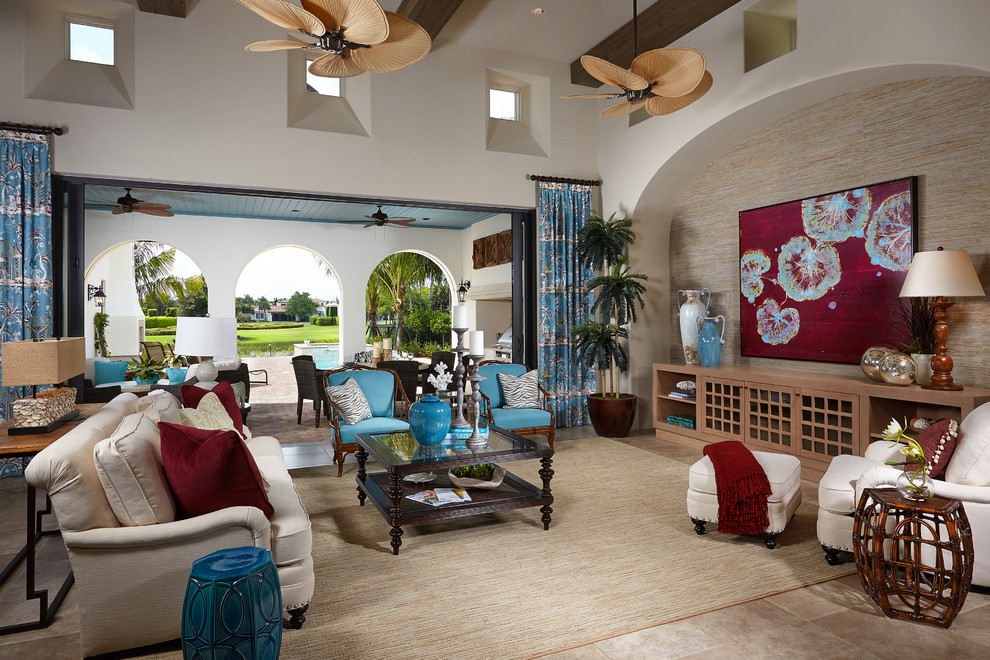 This is an example of a tropical open concept living room in Miami with white walls.