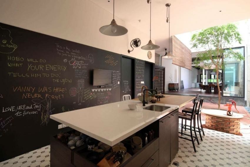 Inspiration for a large contemporary galley seated home bar in New York with an undermount sink, flat-panel cabinets, dark wood cabinets, limestone benchtops, ceramic floors and white floor.