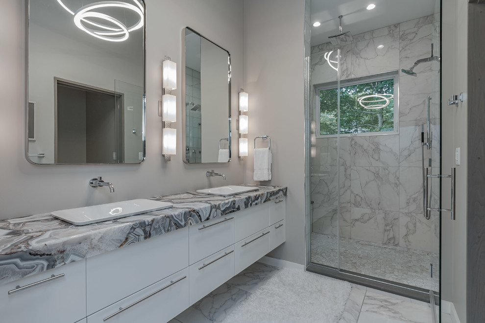 Inspiration for a mid-sized contemporary master bathroom in Other with flat-panel cabinets, white cabinets, a two-piece toilet, white tile, porcelain tile, beige walls, porcelain floors, a vessel sink, white floor and multi-coloured benchtops.