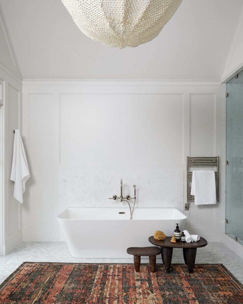 Inspiration for a transitional bathroom in New York with a freestanding tub, white tile, white walls, mosaic tile floors, white floor and panelled walls.