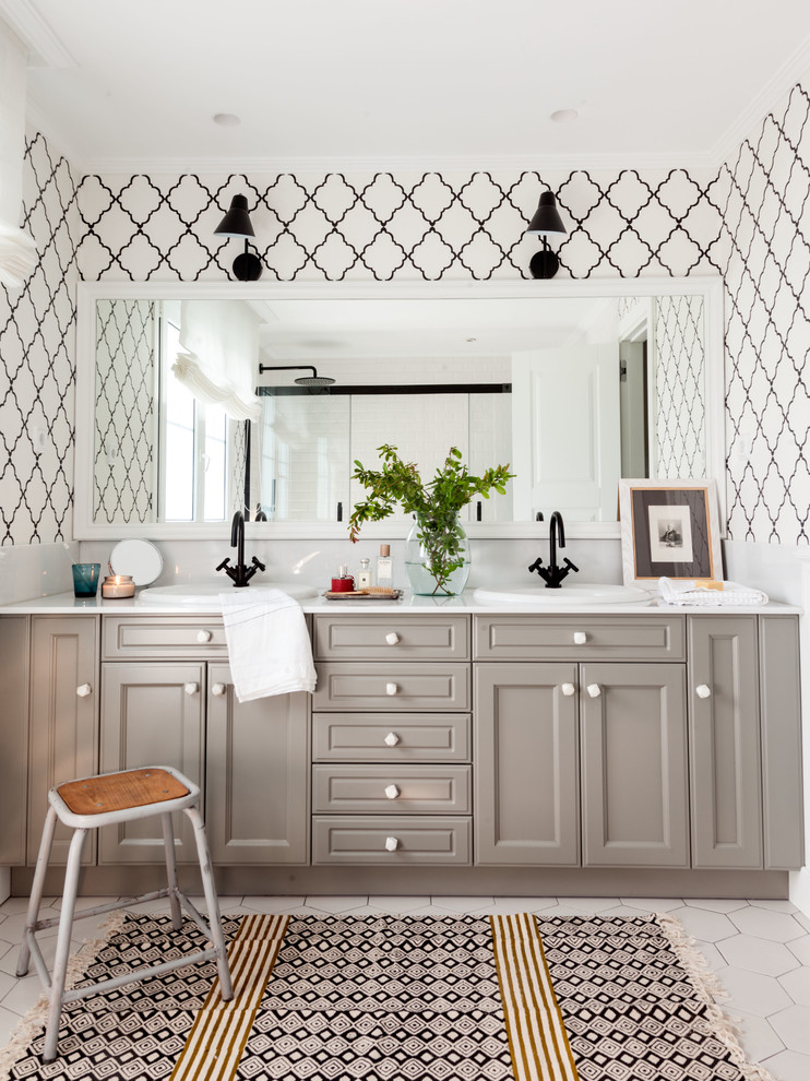 Inspiration for a transitional bathroom in Bilbao with grey cabinets, white walls, a drop-in sink, white floor, white benchtops and recessed-panel cabinets.