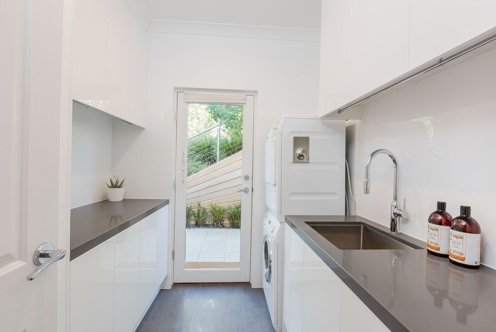This is an example of a small contemporary galley kitchen in Adelaide with porcelain floors, grey floor, a drop-in sink, raised-panel cabinets, white cabinets and green benchtop.