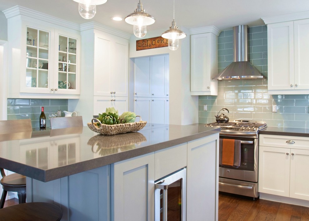Open concept kitchen - mid-sized transitional l-shaped medium tone wood floor and brown floor open concept kitchen idea in Orange County with an undermount sink, shaker cabinets, white cabinets, quartz countertops, green backsplash, glass tile backsplash, stainless steel appliances and an island